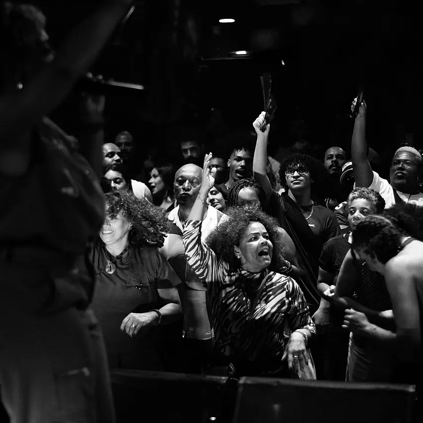 A plateia de braços pro alto, cantando junto na frente do palco da Black SP
